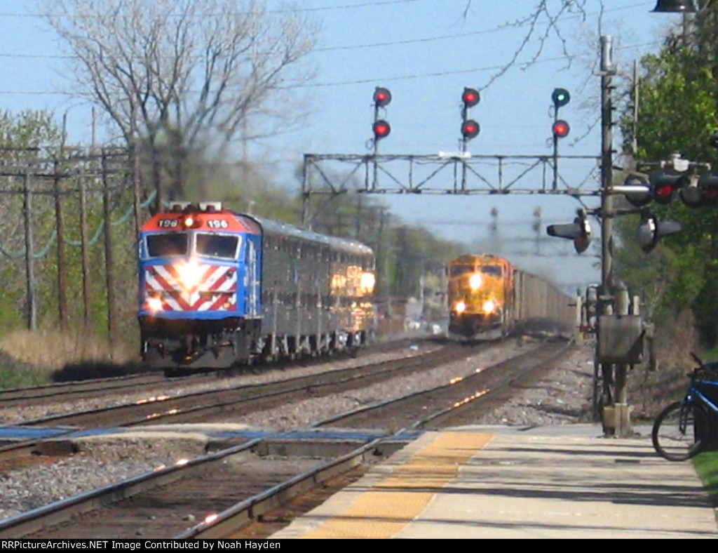 Metra outbound from Chicago overtaking BNSF coal with SD70mac Leading